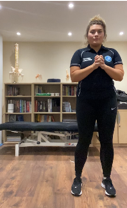 A person standing in a room  Description automatically generated