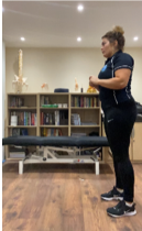 A person standing in front of a book shelf  Description automatically generated